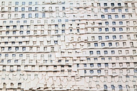 Close-up of overlapping ripped and torn out white perforated pages background from spiral bound