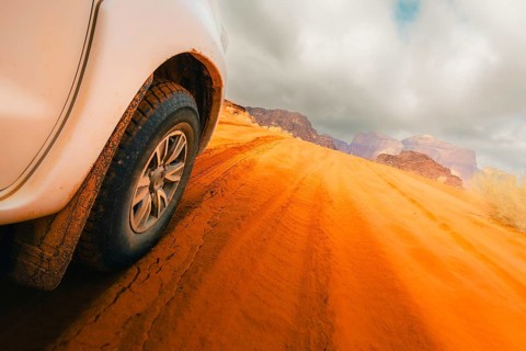 Jordan - 25th october, 2025: Close up 4wd vehicle driving across Wadi rum red sand track with