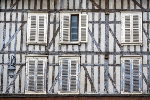 Detailed view of a historic half-timbered house with closed shutters in the old town of Troyes,