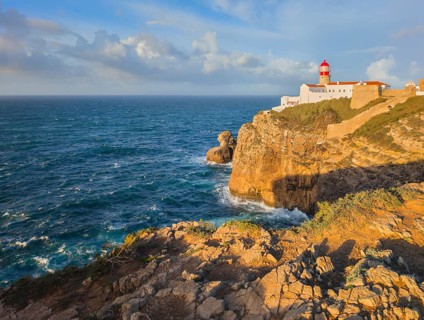 View of the Lighthouse of Cabo de Sao Vicente in Sagres, Algarve, Portugal, at sunrise with