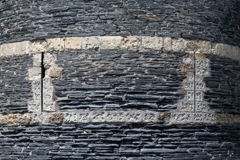 Detailed view of one of the mighty defensive towers with narrow, vertical loopholes, built of slate