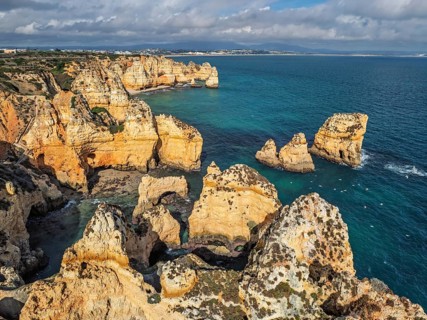 Drone view of Ponte da Piedade in Lagos, Algarve, Portugal, with cliff coves, sea stacks and clear