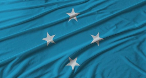 Micronesia flag waving. Flag of Micronesia with cloth texture