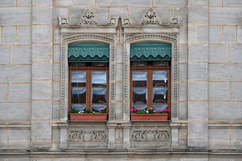 Historic windows from the 19th century, with green, decorative metal shutters, Unterer Markt 5,
