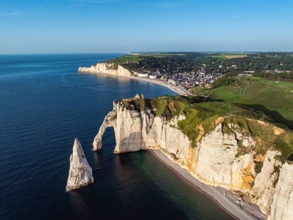 Aerial view of the Porte d'Aval rock formation in the evening sun, well-known sights on the chalk