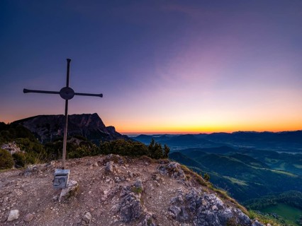 Dawn at the summit cross of Rauhen Kopf, behind the Untersberg, Berchtesgaden Alps, Bischofswiesen,