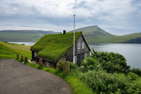 Traditional house with grass roof in the village of Bøur, Vágar Island, Faroe Islands, Denmark