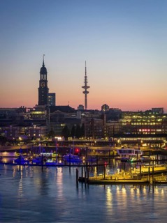 Aerial view of Landungsbrücken at sunrise on the Elbe with St Michael's Church (Michel) and