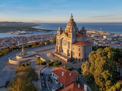 Drone photo of Santa Luzia sanctuary at sunrise above Viana do Castelo, Portugal, with a coastal
