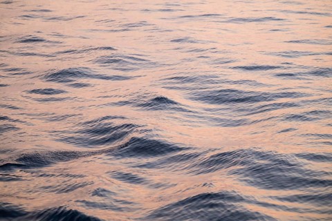 Gentle waves of the Mediterranean reflect a pink-blue light with a calm atmosphere, Aeolian or