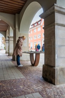 Person looking at a city model under arcades in the city, Isny, Allgäu, Bavaria, Germany
