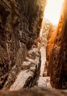 Aerial viewpoint Little Petra Jordan canyon and tourists walking walk sightseeing sandstone