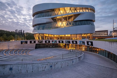 08.05.2026 Modern Mercedes Benz Museum building at dusk with illuminated facade and amphitheater in