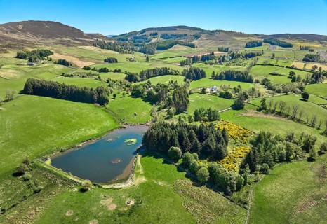 Aerial drone photo of agricultural landscape with meadows and pastures at the border of the Cairn
