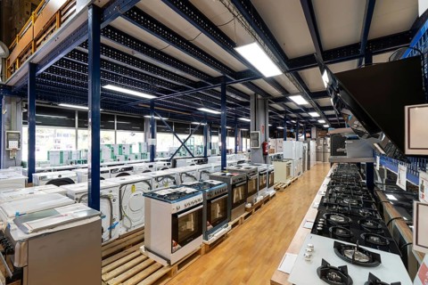 Modern retail store interior displaying a wide selection of new home appliances including washing