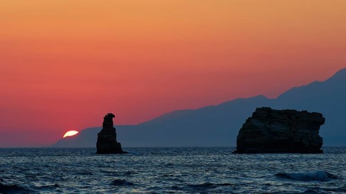 Calming sunset over the sea with a rock and mountains on the horizon, sunset, South of the Amari