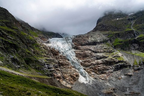 Dramatic mountain landscape covered in clouds with Lower Arctic Sea glacier, Bernese Alps, Bernese