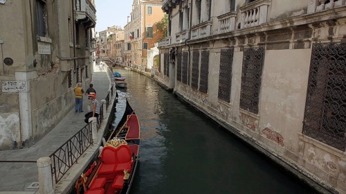 Gondola on a canal in Venice surrounded by old buildings, Venice, Veneto, Italy