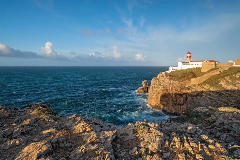 View of the Lighthouse of Cabo de Sao Vicente in Sagres, Algarve, Portugal, at sunrise with