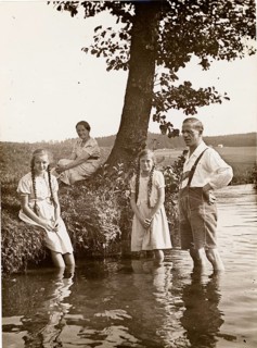 Bathing, swimwear, leisure, summer, woman, man, girl, family standing in water near a tree on a