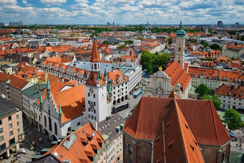 Elevated shot of the Altes Rathaus tower and the historic Marienplatz area with buses and traffic