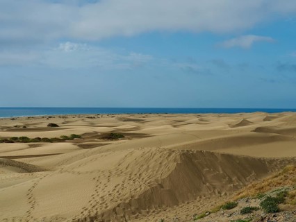Wide dune landscape covered by clouds with views of the sea, dunes of Maspalomas, Gran Canaria,
