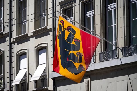Flag of the canton of Bern with the Bernese bear on a house façade, city center, Bern, Canton of