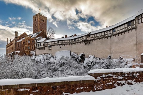 Snowy castle with tower and timbering under sunny sky, The Wartburg near Eisenach in Thuringia