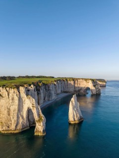 Aerial view of the Porte d'Aval rock formation in the evening sun, well-known sights on the chalk