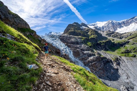 Mountaineers on a hiking trail, picturesque high-alpine mountain landscape with Lower Arctic Sea