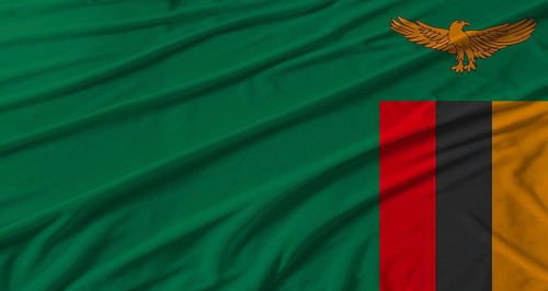 Zambia flag waving. Flag of Zambia with cloth texture