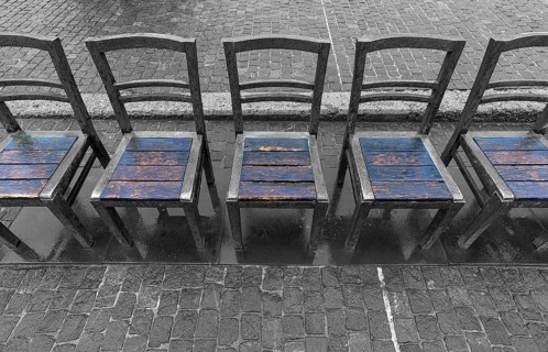 The sixty chairs memorial on the grounds of the Jewish ghetto, black and white, Krakow, Poland