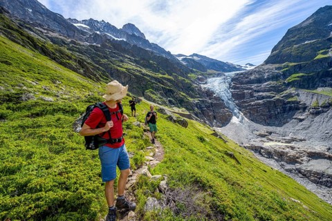 Mountaineers on a hiking trail in front of picturesque high alpine mountain landscape with Lower