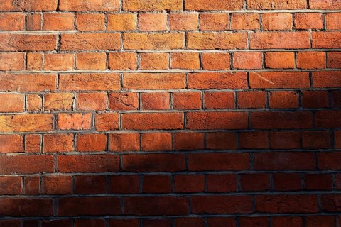 Brick wall made of brown-red, partly shaded bricks, Chelsea, London, England, Great Britain