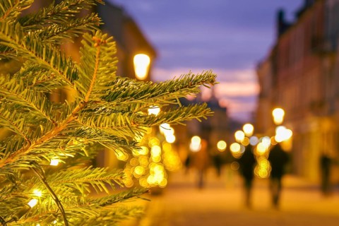 Blurred zoom out background city street with Christmas illuminations, blurred holiday background.