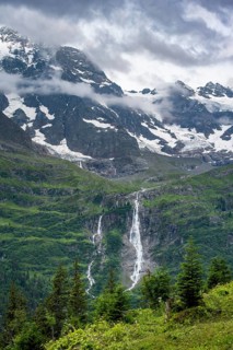 Picturesque mountain landscape with Schmadribachfall waterfall, Breithorn mountain summit, Bernese