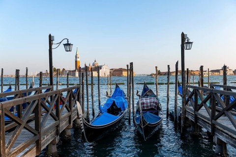 Venetian gondolas, boat launch at St. Mark's Square, San Giorgio Maggiore church in the evening