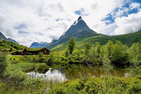 Traditional house with grass roof on a small pond, Renndølsetra, Innerdalen high valley,