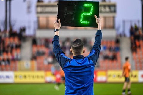 Sideline referee shows 2 minutes added time during the football match in Glogow, Poland