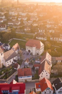 Bird's-eye view of village in warm light with historic architecture, Deufringen, Aidlingen,