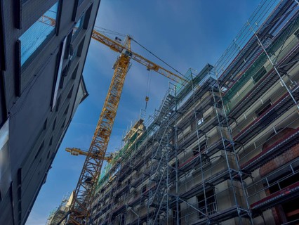 Scaffolding, equipped house, yellow crane, Munich, Bavaria, Germany