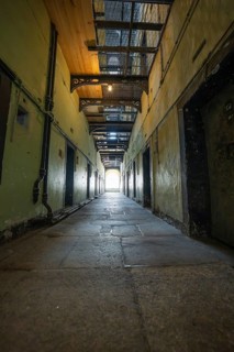 Long yellow prison corridor with lights, Kilmainham Gaol prison, Dublin, Ireland