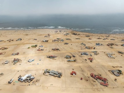 The odd holiday settlement of Wlotzkasbaken at the Atlantic coast. Aerial view. Drone shot. Namib
