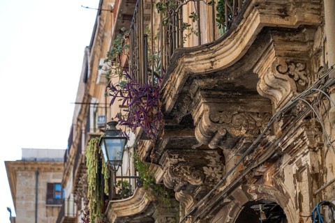 Weathered, richly ornamented balconies of a historic building, Palermo, Sicily, Italy