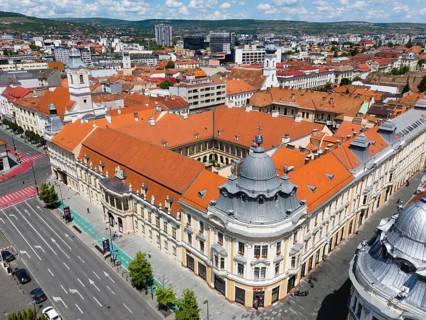 View of a city with red roofs and historic buildings in sunny surroundings, aerial view, Bánffy
