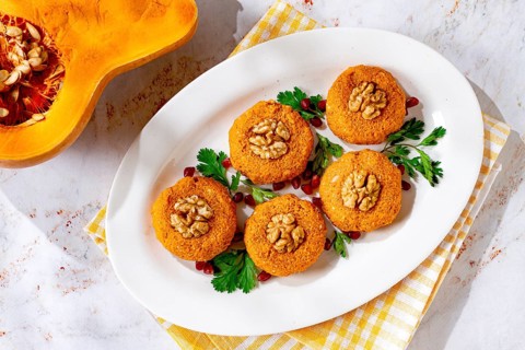 Pumpkin phali, Georgian dish, on a white plate, pumpkin appetizer with nuts and spices, no people,