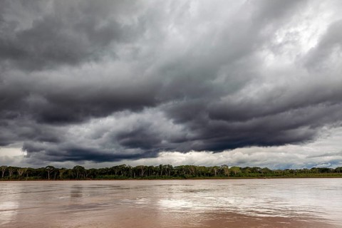 Threatening clouds over a river and wooded bank, The Beni River near Rurrenabaque in the Amazon