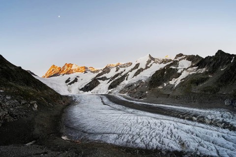 Impressive high-alpine landscape, Finsteraarhorn and Agassizhorn mountain peaks with alpine glow at