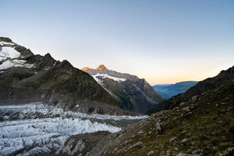 Impressive high-alpine landscape, Eiger mountain summit with alpine glow at sunrise, Upper Arctic
