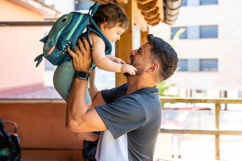 Loving father and young son bonding outdoors, engaging in playful interaction with a joyful